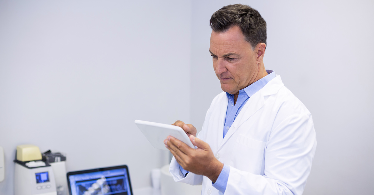 dental equipment | dentist at work | dentist looking over paperwork